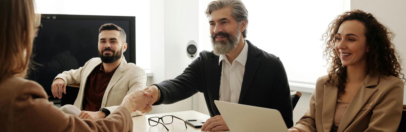 people shaking hands in management team